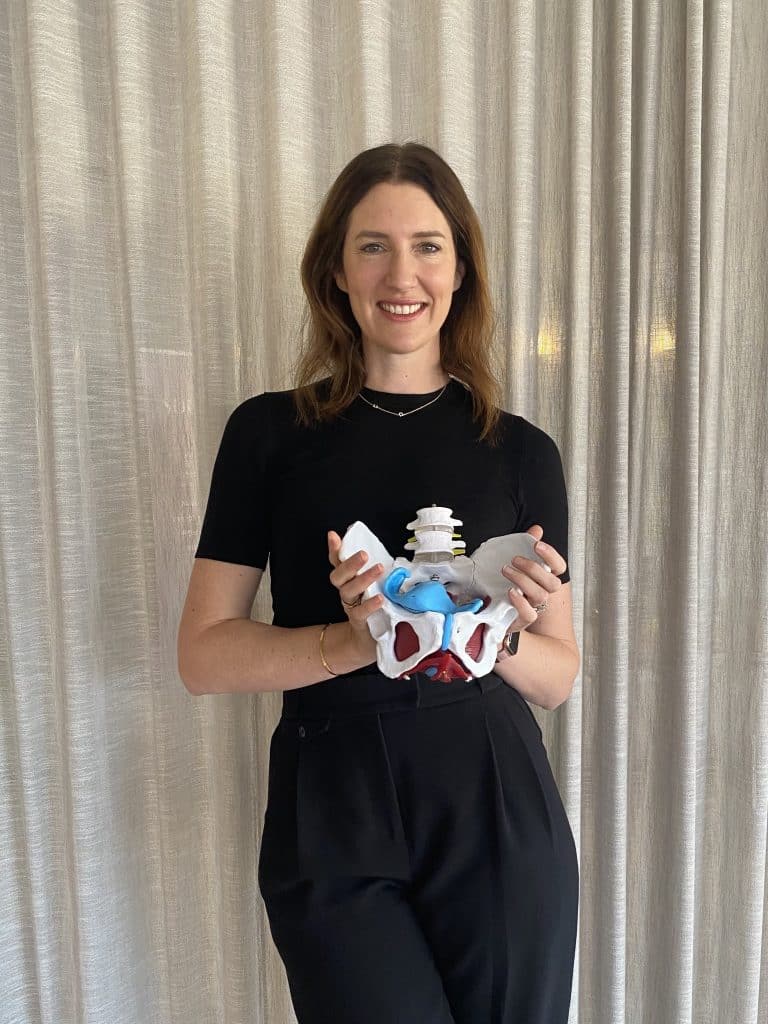 Kate smith, physiotherapist holding a pelvis